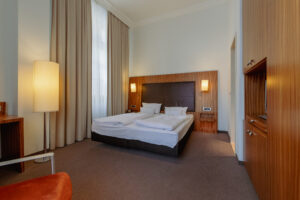 Das komfortable Bett im Doppelzimmer M im Herzogshof Boutique-Hotel am Dom